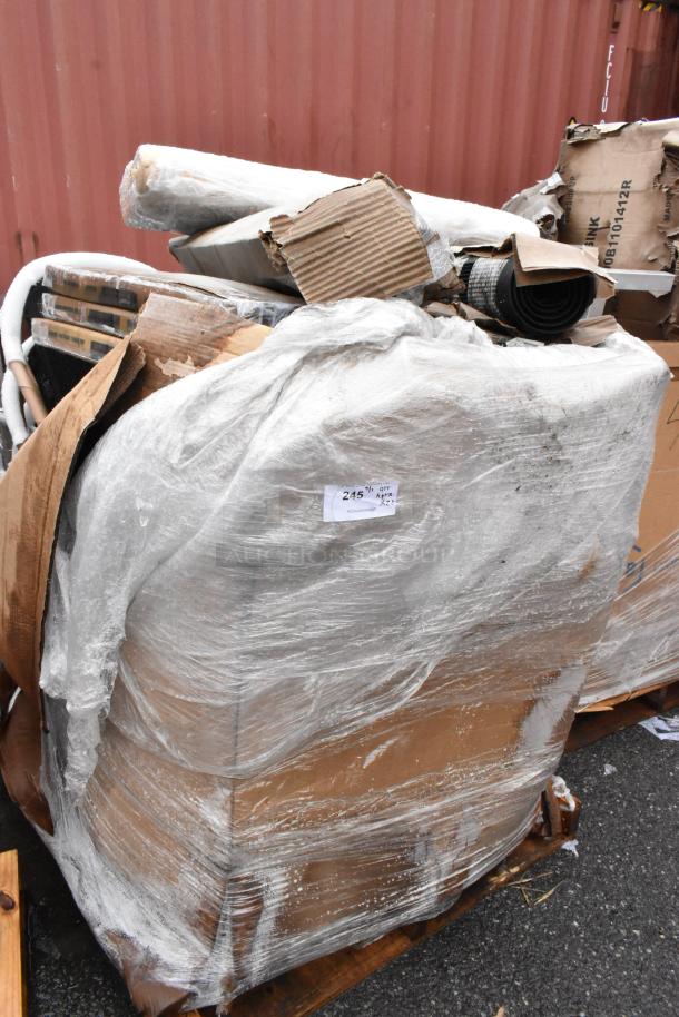 Pallet with wrapped mixed goods and cardboard, showing a tag with "Qty: 245." Items appear to be in used condition.