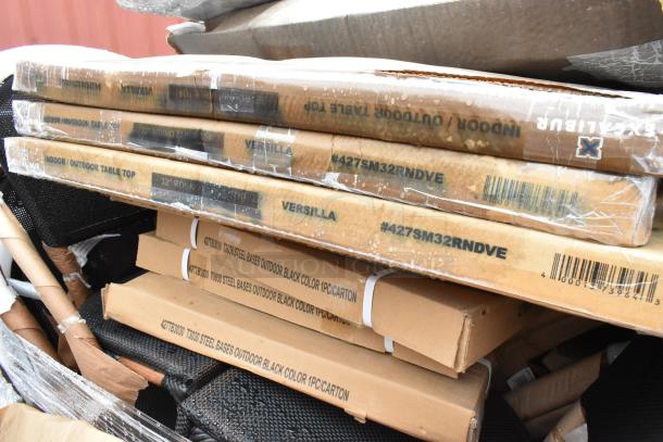 Stack of packaged indoor/outdoor table tops and steel bases, marked with model #427SM32RNDVE and dimensions. New condition.