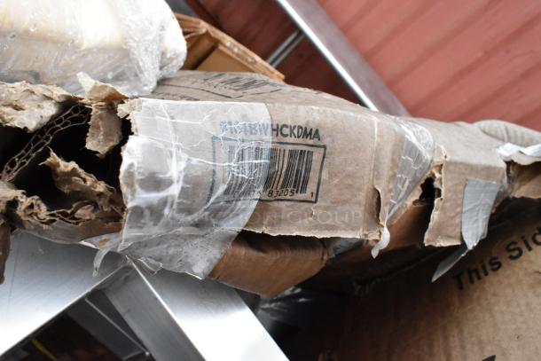 Worn cardboard box with barcode 078738205 and markings, heavily taped, showing signs of damage and tears.