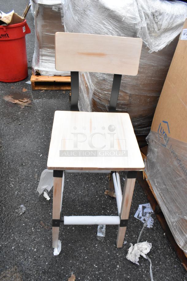 Wooden bar stool with backrest, light finish, metal frame supports, good condition, minor visible wear.