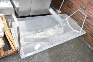 Large clear acrylic display case with metal frame, slightly worn condition, suitable for commercial use.