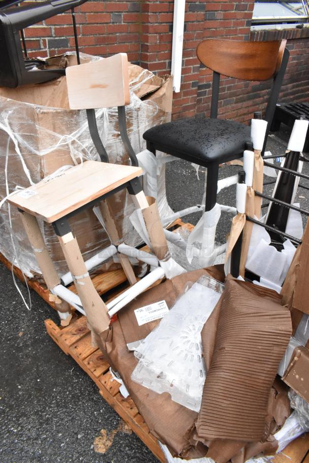 Set of wooden and metal chairs on a pallet. One chair has water droplets. Tags visible. Unassembled, in new condition.