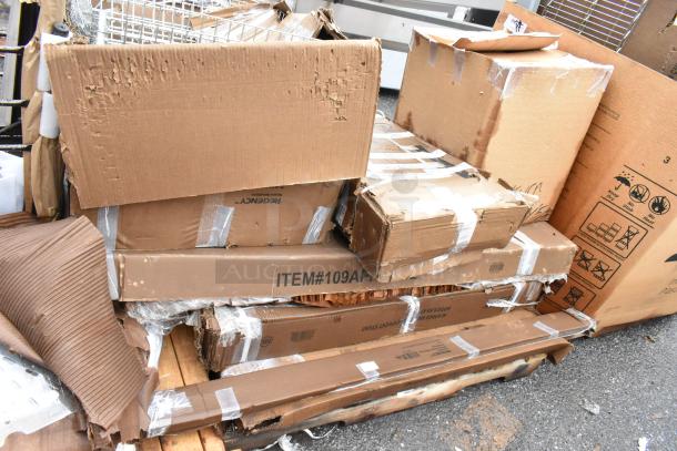 Stack of damaged cardboard boxes, some marked "ITEM#109AP," with visible tape and wear, indicating potential shipping or storage issues.