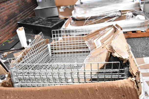 Metal wire baskets in a partially opened cardboard box, with visible labels and packaging damage.