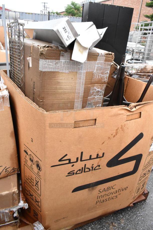 Large box of SABIC Innovative Plastics in worn condition, containing metal parts with visible tape and shipping labels.