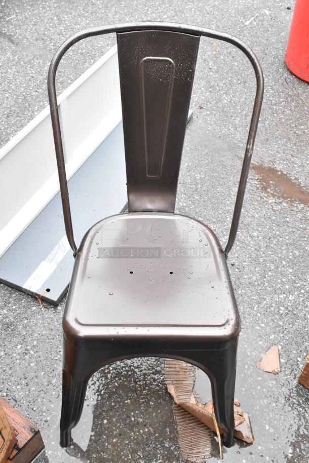 Vintage metal chair with curved back, dark finish, visible wear, droplets on seat, suitable for indoor/outdoor use.