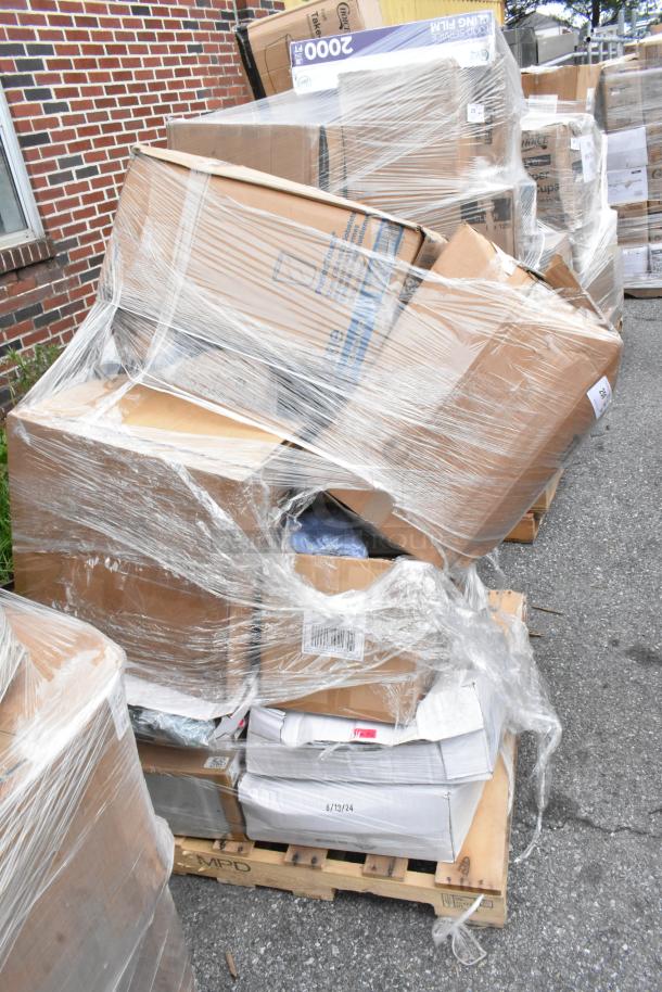 Pallet with assorted cardboard boxes, wrapped in plastic, some visible labels noting quantities and dates. Exterior conditions mixed.