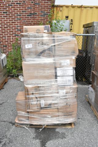 Pallet of various packaged disposable cups and plates wrapped in plastic. Visible labels include brand and product details.