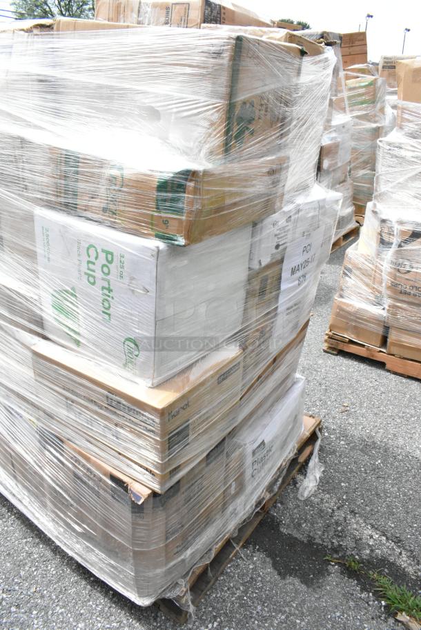 Pallet of assorted boxes wrapped in plastic film, visible labels indicate "Portion Cup" and "Plastic Cup." Outdoor setting.
