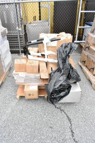 Pallet of mixed cardboard boxes and plastic-wrapped items. Various labels visible, some indicating recycling symbols.