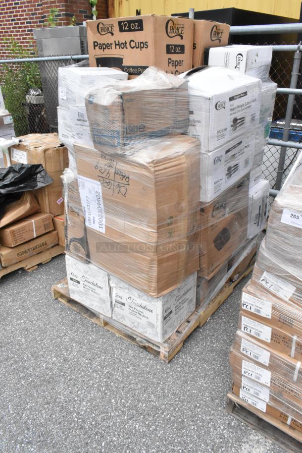 Pallet of assorted boxes including Choice paper hot cups, Dixie items, and Touchstone napkins. Wrapped in plastic for shipping.