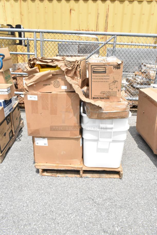 Pallet with assorted cardboard boxes, including Rubbermaid mop bucket box, condition appears mixed; labels visible.