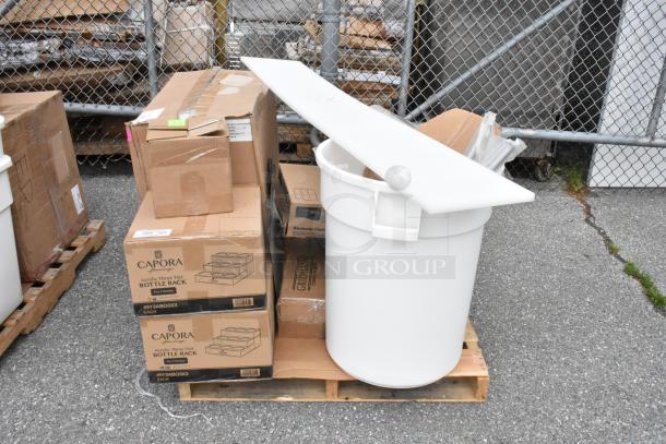 Pallet with Capora bottle rack boxes and a large white plastic bin. Items appear in good condition.