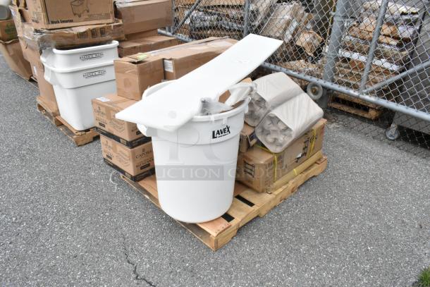 Large white Lavex trash can with lid, atop a pallet with boxed items. Barriers and other containers visible in the background.