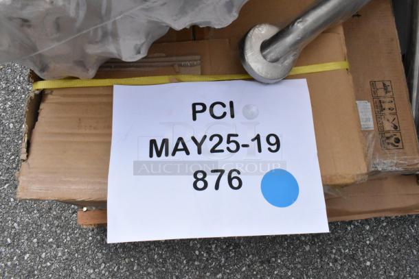 Cardboard box with label "PCI MAY25-19 876" and blue dot, indicating delivery or auction details.