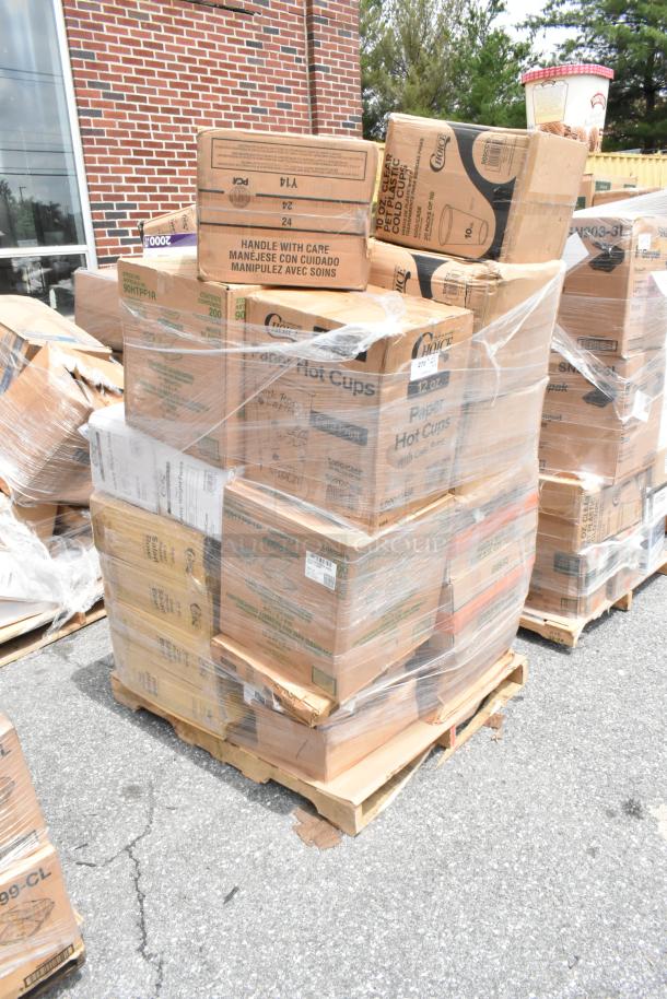 Pallet of boxed paper hot and cold cups, wrapped in plastic, marked "Handle with Care," ready for auction.
