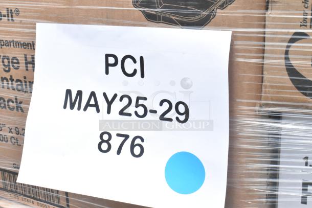 Cardboard boxes wrapped in plastic, labeled with "PCI MAY25-29 876" and a blue dot sticker, indicating shipment details.