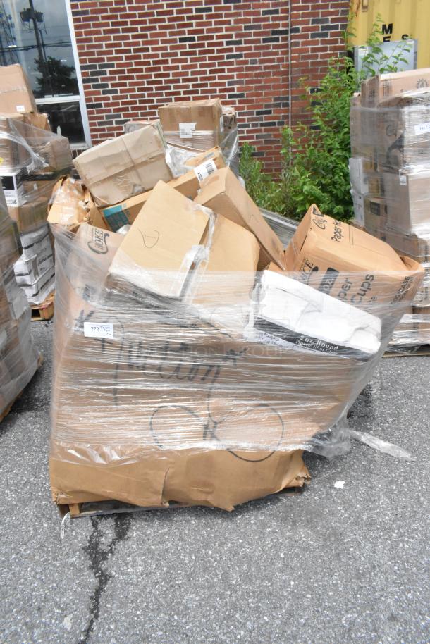 Pallet of assorted cardboard boxes wrapped in plastic, mixed condition, includes labeled boxes, outdoor setting.