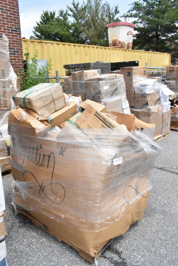 Pallet of assorted cardboard boxes, shrink-wrapped, with "Auction" written on side; includes bakery boxes and paper cups.