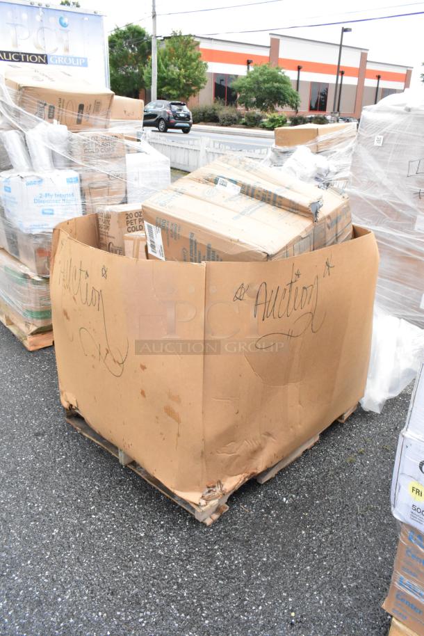 Large cardboard box labeled "Auction" containing assorted items, placed on a wooden pallet, showing signs of wear.