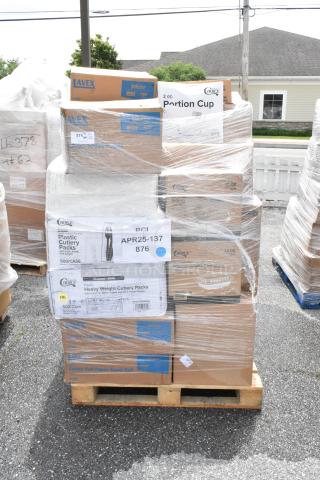 Pallet of various boxed items including Lavex paper towels and Choice cutlery packs, shrink-wrapped for shipping.