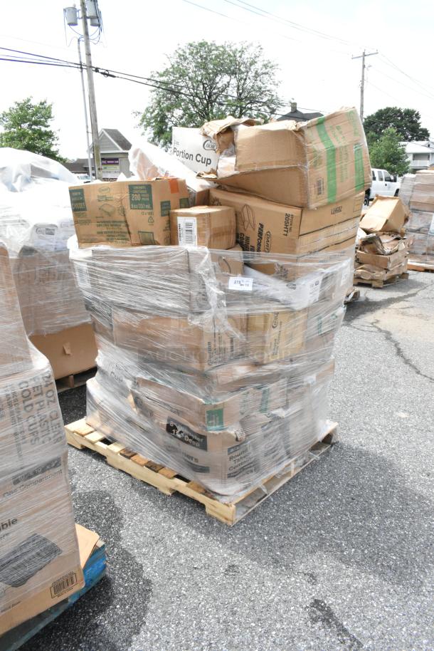 Pallet of assorted cardboard boxes wrapped in plastic. Boxes labeled "Choice Portion Cup" and "Dart", indicating food packaging materials.