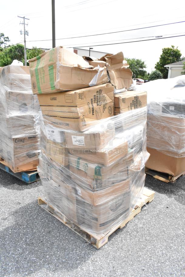 Pallet of stacked cardboard boxes wrapped in plastic, some boxes are damaged, marked with shipping labels and product details.