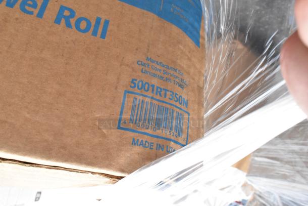 Brown cardboard box with "Towel Roll" text, model 5001RT350N, barcode, and "Made in USA" label. Manufactured for Clark Core Services.