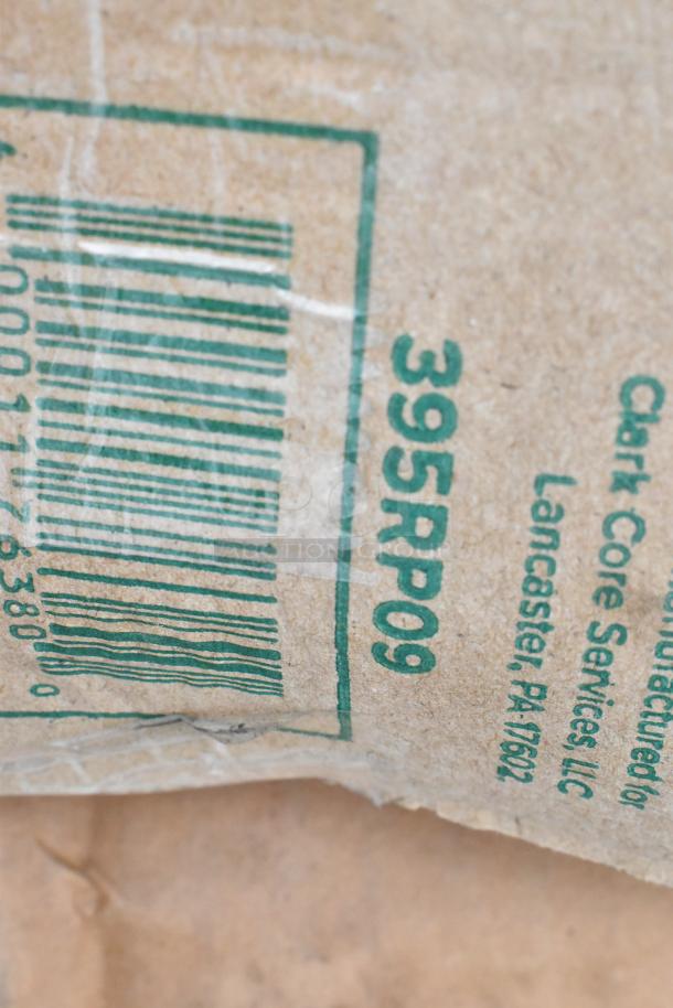 Close-up of a labeled cardboard package with barcode, marked "395RP09." Manufactured by Clark Core Services, Lancaster, PA 17602.