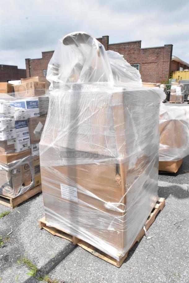 Pallet of assorted boxes wrapped in clear plastic, outdoors. Some boxes labeled "Noble" for disposable gloves.