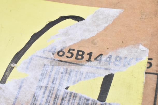 Partial cardboard box with torn yellow label, exposing printed code "65B1448." Edges show wear and peeling.