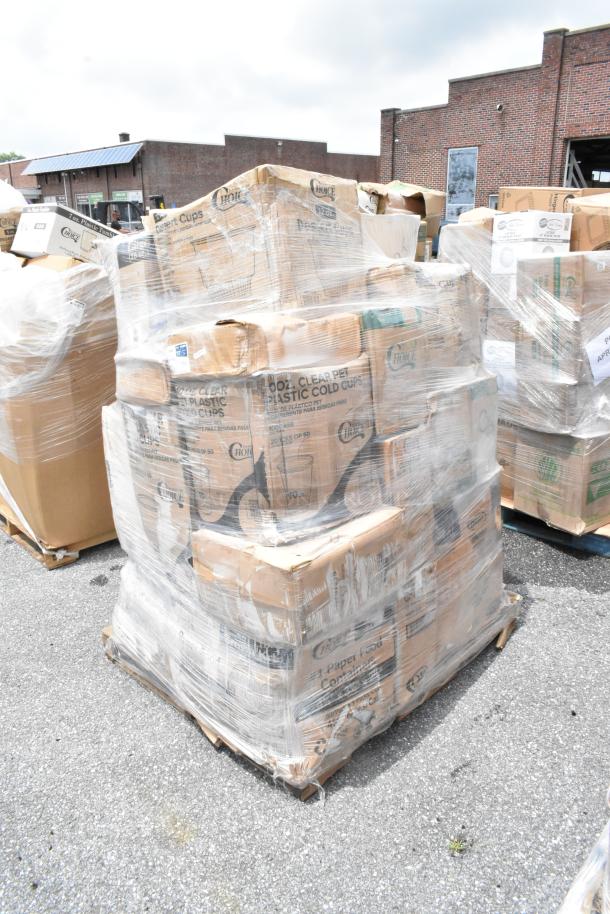 Pallet of assorted Choice Cool Clear PET plastic cold cups, shrink-wrapped, with visible box labels, outdoors. Condition appears good.