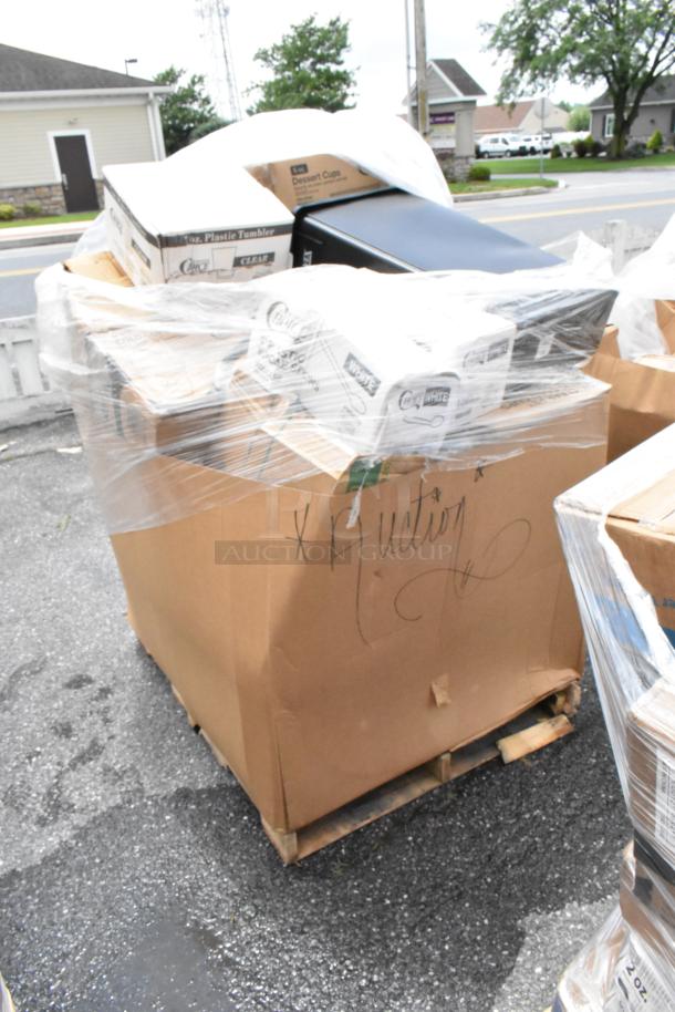 Pallet of assorted plastic tumblers and dessert cups in damaged cardboard, marked "Auction," wrapped in plastic.