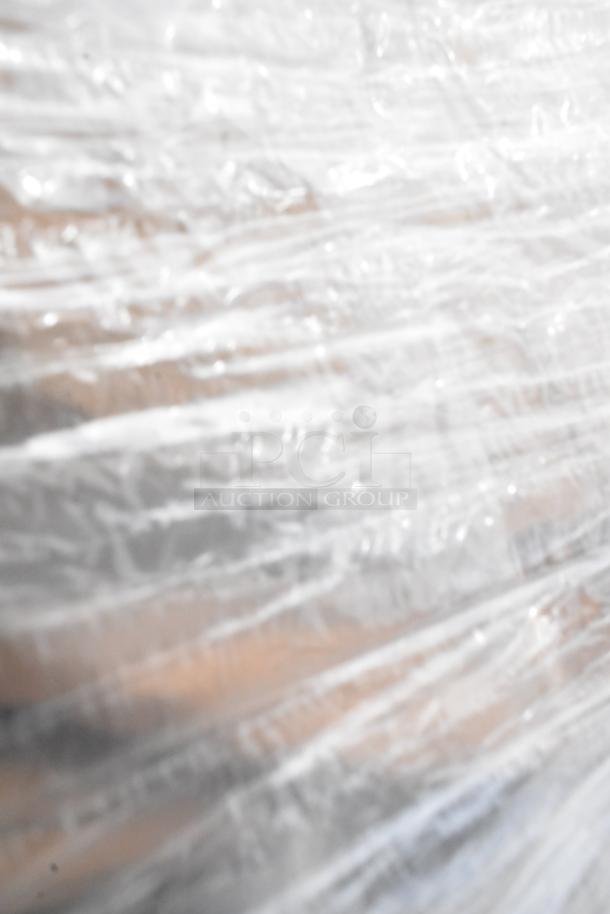 Blurred image of an object wrapped in clear plastic. Details and features are indistinguishable.