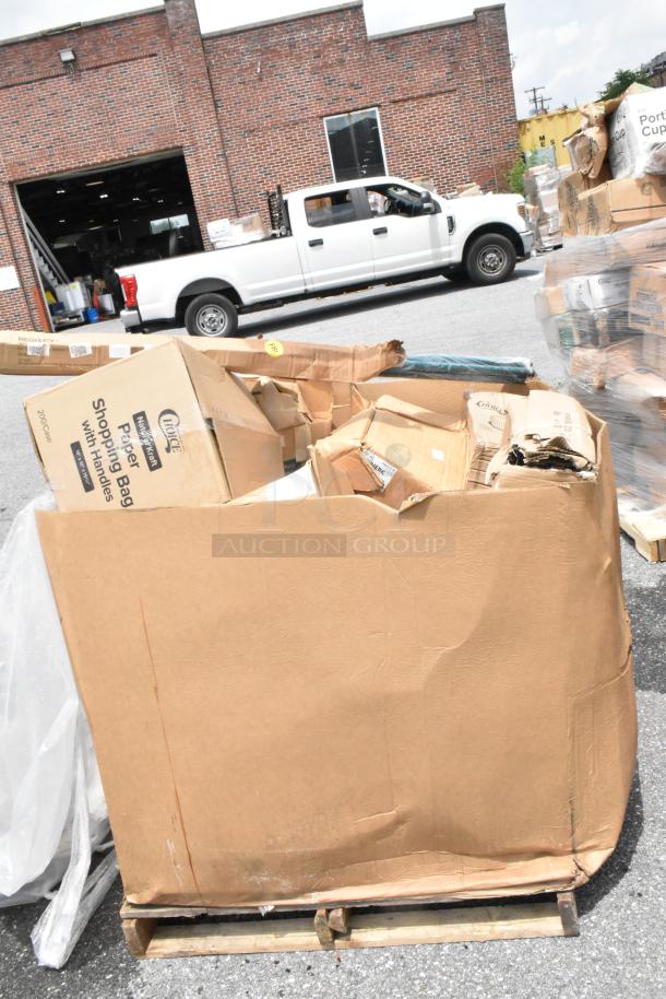 Large pallet of assorted cardboard boxes, some labeled "Choice Shopping Bags," appears in used condition near a brick warehouse.