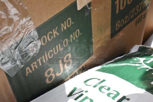 Cardboard box with "STOCK NO. ARTÍCULO NO. 8J8" printed, 8 oz, clear vinyl packaging partially visible.