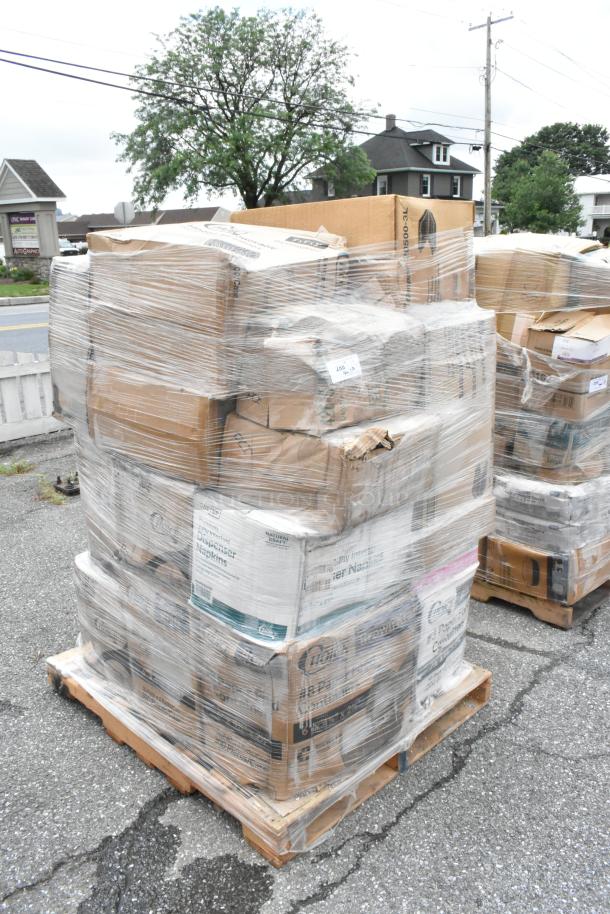 Pallet of boxed dispenser napkins shrink-wrapped for auction. Boxes appear in varied condition with visible product labels.