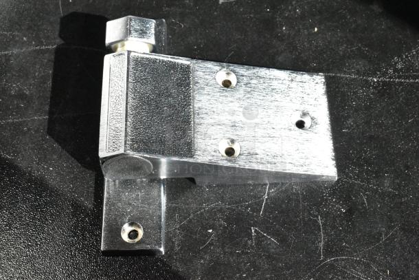 Metal hinge bracket with three screw holes, textured finish. Polished and in new condition, suitable for heavy-duty use.