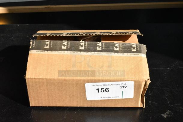 Cardboard box with black tape labeled "Craftsmanship Quality." A sticker reads "156 QTY, PCIAuctions.com." Box is slightly open.