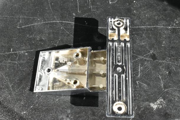 Metal bracket with triangular base, marked "Kason" and model number "1255-18-464." Features holes for mounting.