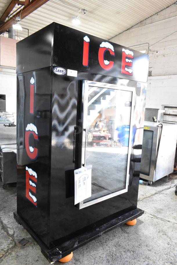 Black Leer ice vending machine, glass door, large "ICE" lettering with snow design, in good condition.