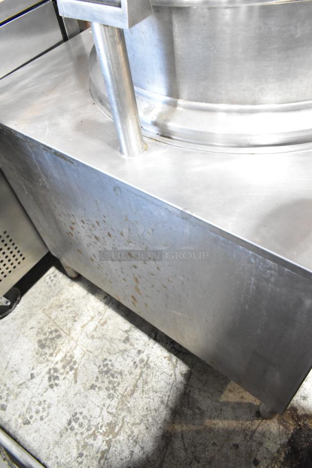 Commercial stainless steel kettle, industrial-grade, with visible wear marks. Durable, robust, for professional kitchen use.