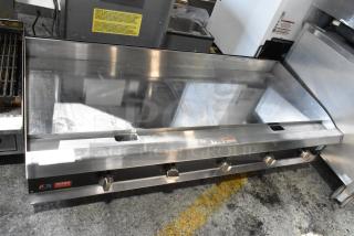 Commercial stainless steel flat-top griddle, four control knobs, minor surface wear, CPG Ultra Series label visible.