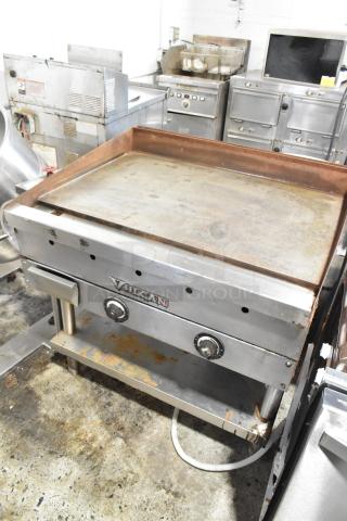 Vulcan commercial griddle with dual controls, showing signs of wear and rust, ideal for restaurant kitchens.