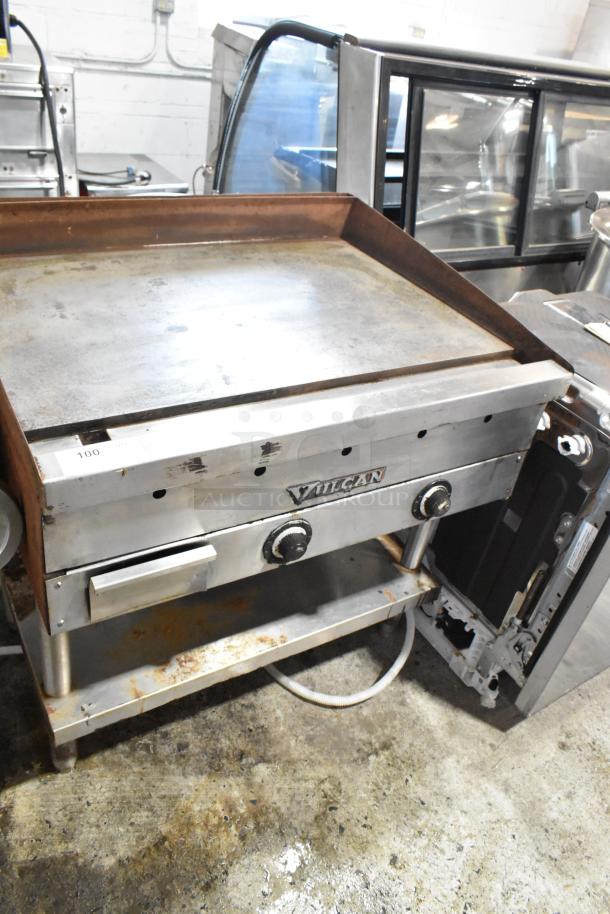 Vulcan commercial griddle with dual control knobs, stainless steel body, showing signs of use, model tag on front.