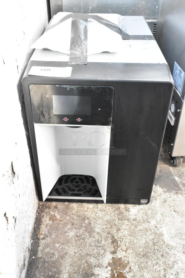 Black and white commercial ice dispenser, model unknown, used condition, with digital control panel, placed on a concrete floor.