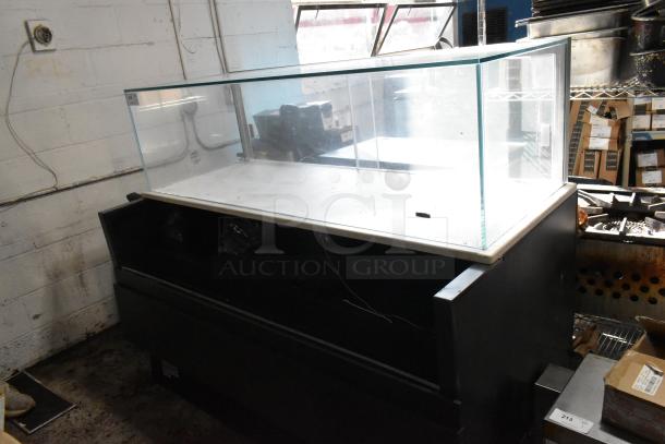 Glass display case with black metal base, featuring a white interior surface. Used condition, suitable for a retail setting.