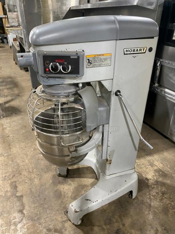 Hobart industrial mixer, model label visible, large stainless steel bowl, manual controls, scratches indicating used condition.