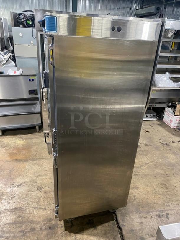 Commercial stainless steel warming cabinet, tall and upright. Features temperature controls on front. Used condition.