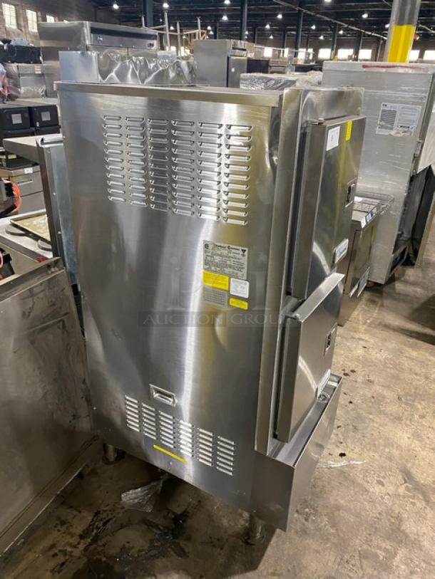 Stainless steel commercial oven with dual doors, vented panels, and labels indicating model specifications. Good condition.